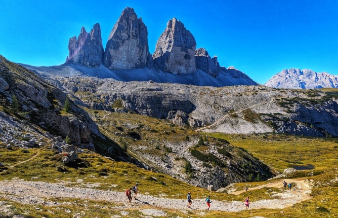 running in front of tre cime