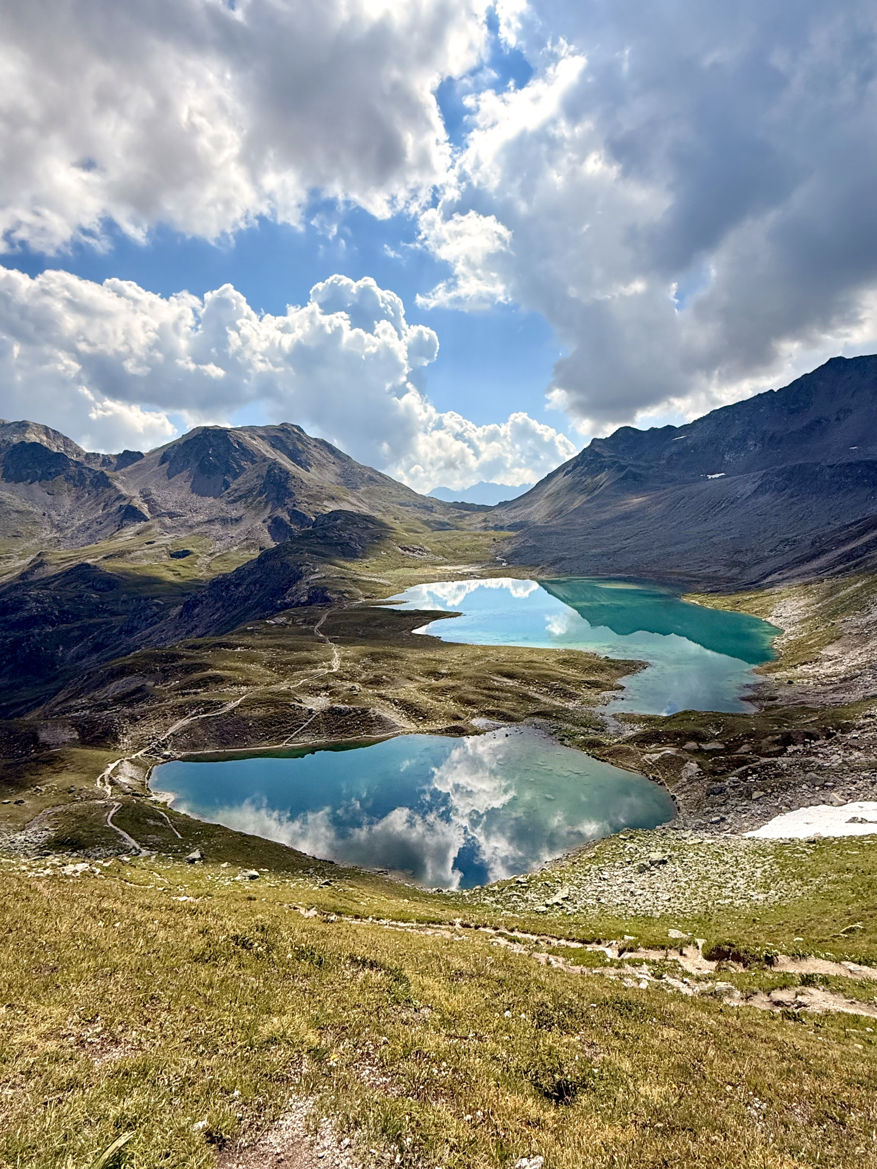 Turquoise alpine lakes above a green valley